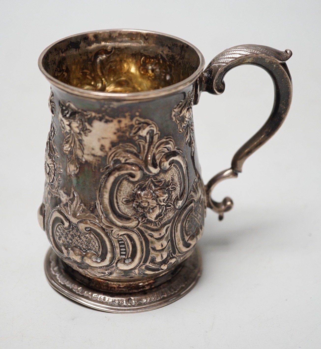 A George III silver small mug, with later embossed decoration, William Cripps, London, 1775, 95mm, 6.1oz.